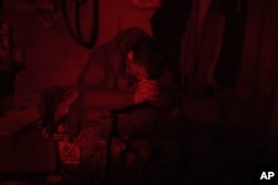 A Ukraine Special Operations Forces soldier rests inside a shelter as he waits to pilot a drone during a night mission in Kherson region, Ukraine, on June 10, 2023.