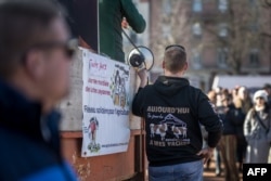 A Swiss farmer with a sweatshirt reading "today I only speak to my cows" attends a Geneva protest over pay, tax and regulations, Feb. 3, 2024, as farmers take part in demonstrations across Europe.