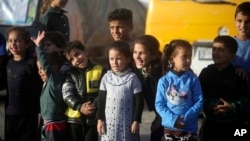 Displaced Palestinian children sheltering at a UN school, attend a performance in Rafah refugee camp, southern Gaza Strip, Nov. 23, 2023.
