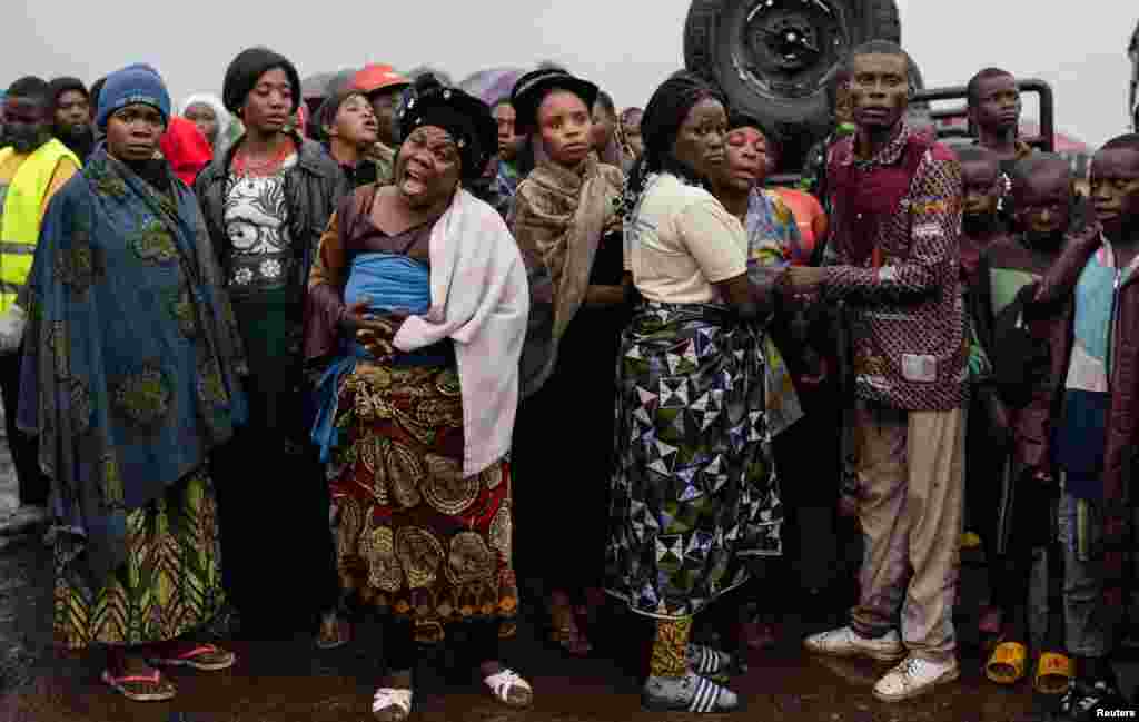 Relatives react as the coffin of a protester killed during a demonstration against the presence of the United Nations Organization Stabilization Mission in the Democratic Republic of the Congo and East Africa Community Regional Force, is carried before burial at the Makao cemetery in Goma, North Kivu province, Sept. 18, 2023.