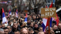 Kosovo Serbs gather as they take part in a protest to oppose the decision by the Central Bank of Kosovo that announced the euro as the only legal currency that can be used in cash operations, in Mitrovica, Feb. 12, 2024.