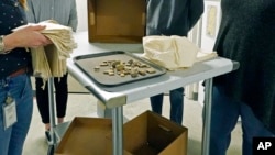 FILE — Artifacts sit outside the Two Museums' Archaeology Collections Storage room in Jackson, Mississippi, March 19, 2021. At the time, Chickasaw ancestors and artifacts had been collected and were to be repatriated to Native hands to be laid in their final resting place.