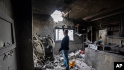 Hussein Fawaz inspects damages to his family house that was hit by Israeli shelling in the Kfar Kila border village with Israel in south Lebanon, Nov. 25, 2023.