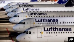FILE - Lufthansa aircrafts are parked at the airport in Frankfurt, Feb. 7, 2024. A union has called on ground staff for Lufthansa at seven German airports to walk off the job for a day on Tuesday, following a similar strike earlier this month.