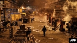 FILE - Steelworkers walk at the Iran National Steel Industrial Group facility in Ahvaz in Iran's southwestern Khuzestan province on Dec. 22, 2020. 