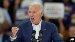 US President Joe Biden gestures during his remarks at Renaissance High School in Detroit campaign event, July 12, 2024.