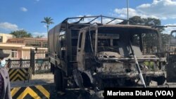 A police truck is burned in front of the Kenya parliament on June 25, 2024.