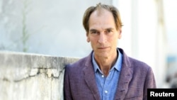 FILE - Actor Julian Sands poses before an interview at the 76th Venice Film Festival screening of the film "The Painted Bird" in Venice, Italy, Sept. 3, 2019.