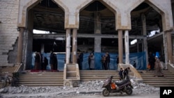 Palestinians pray in a damaged mosque following an Israeli strike in Rafah, southern Gaza Strip, Feb. 15, 2024.