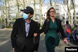 一名美国律师陪着纽约华裔居民卢建旺（译音：Lu Jianwang）走出布鲁克林联邦法庭。(2023年4月17日)