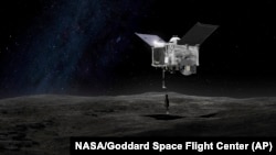 FILE - This artist's rendering made available by NASA on shows the Origins Spectral Interpretation Resource Identification Security - Regolith Explorer (OSIRIS-REx) spacecraft contacting the asteroid Bennu with the Touch-And-Go Sample Arm Mechanism.