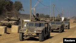 Konvoi kendaraan militer Israel bergerak di sepanjang jalan, di tengah invasi darat yang sedang berlangsung di Jalur Gaza terhadap kelompok Islam Palestina Hamas hari Rabu, 8 November 2023.