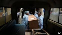 Health care workers load the coffin of a person who was killed in Friday's train accident into an ambulance at a hospital in Bhubaneswar, in the eastern state of Odisha, India, June 5, 2023.