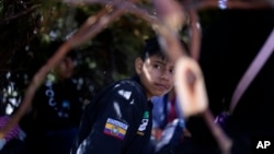 A group of asylum-seekers from Ecuador wait in a makeshift camp after crossing the nearby border with Mexico, Sept. 20, 2023, near Jacumba Hot Springs, Calif.