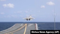 FILE - In this photo released by Xinhua News Agency, a J-15 Chinese fighter jet takes off from the Shandong aircraft carrier during military exercises around Taiwan by the Eastern Theater Command of the Chinese People's Liberation Army, April 9, 2023.