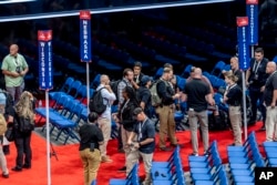 Security agents prepare for a sweep of the Fiserv Forum ahead of the 2024 Republican National Convention, July 13, 2024, in Milwaukee, Wisconsin.