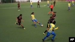 Women footballers compete in a soccer match between ASFAR and ASDCT Ain Atiq, in Morocco's professional women league, in Rabat, Morocco, Wednesday, May 17, 2023. (AP Photo/Mosa'ab Elshamy)