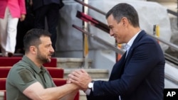 Photo from Ukrainian Presidential Press Office. Ukrainian President Volodymyr Zelenskyy, left, and Spain's Prime Minister Pedro Sanchez shake hands in Kyiv, Ukraine, July 1, 2023.