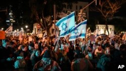 Demonstrators gather in Tel Aviv, Israel, to call for early elections and protest against Israeli Prime Minister Benjamin Netanyahu and his handling of the Israel-Hamas war, Feb. 17, 2024.