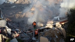 Palestinian emergency services look for survivors after an Israeli strike on a residential building in Rafah, Feb. 19, 2024.