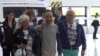 This grab taken from pool video footage made available by LCI television network shows French citizen Louis Arnaud flanked by his mother and father upon arrival at Le Bourget airport, north of Paris, June 13, 2024. 