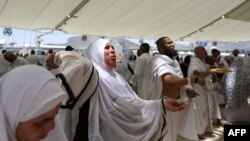 Muslim pilgrims perform the symbolic stoning of the devil ritual as part of the hajj pilgrimage, in Mina, near Saudi Arabia's holy city of Mecca on June 28, 2023.