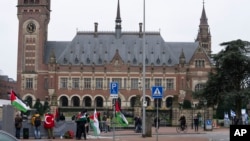 Pro-Palestinian, left, and pro-Israeli demonstrators, right, protest outside the United Nations' highest court during hearings in The Hague, Netherlands, Feb. 21, 2024, into the legality of Israel's occupation of the West Bank and east Jerusalem.