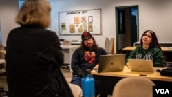 Student reporters Marc Anthony Martinez and Hennessy Machado-Hildalgo talk with Jean Stapleton, chairperson of East Los Angeles College's journalism department and adviser for Campus News, in February 2024 in Los Angeles. (Glenn Zucman/VOA)