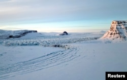 The Kronebreen glacier and its crevasses are seen as the sun sets near Ny-Aalesund, Svalbard, Norway, April 10, 2023.