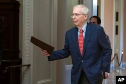 Senate Minority Leader Mitch McConnell of Kentucky walks to the Senate chamber at the Capitol in Washington, Sept. 26, 2023.