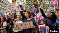 FILE - People chant as striking NHS healthcare staff take part in a protest march amid an ongoing dispute with the government over pay, in London, May 1, 2023. 