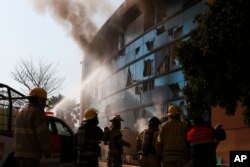 Firefighters work to put out a fire at the municipal government palace set by rural teachers' college students protesting the previous month's shooting of one of their classmates during a confrontation with police, in Chilpancingo, Mexico, April 8, 2024.