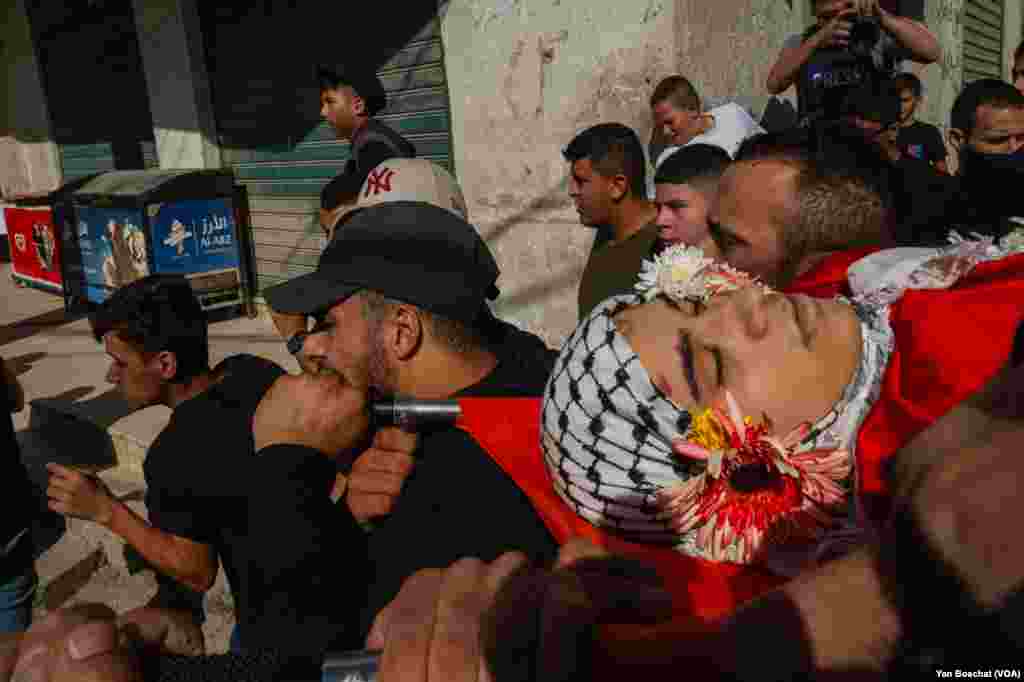 The body of Ahmad Ghaleb, 16, is carreid to the mosque in the Qalandia Refugee Camp for prayers before his funeral, in Qalandia Refugee Camp, Oct. 25, 2023. Ghaleb was killed during a Israeli incursion into the camp to arrest people suspected of being part of the militant group Hamas.&nbsp;