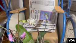 The Khmer Post USA is distributed free throughout the Cambodian community in Lowell, Massachusetts. This distribution point is on a preserved cyclo, or three-wheeled taxi, at the income tax office of Rithy Sao. (Sisovann Pin/VOA)