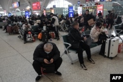 People are seen at Shijiazhuang train station on Feb. 6, 2024.