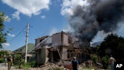 Ukrainian State Emergency Service firefighters put out a fire at a house destroyed in a Russian shelling, in a residential neighborhood, in Kherson, Ukraine, July 1, 2023.