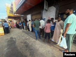 People gather to get bread during clashes between the paramilitary Rapid Support Forces and the army in Khartoum, Sudan, April 18, 2023.