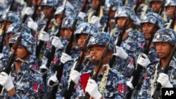 FILE - Military officers march in Naypyitaw, Myanmar, March 27, 2023. On Feb. 10, 2024, Myanmar’s military government activated for the first time a decade-old conscription law that makes young men and women subject to military service if called up.