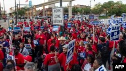 Members of the United Auto Workers (UAW) union march through the streets of downtown Detroit following a rally on the first day of the UAW strike in Detroit, Michigan, on Sept. 15, 2023. 