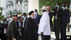 Iran's President Ebrahim Raisi, center-left, shakes hands with Uganda's President Yoweri Museveni, center-right, at the State House in Entebbe, Uganda July 12, 2023.