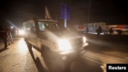 A Red Cross vehicle carrying hostages abducted by Hamas militants during the October 7 attack on Israel arrives at Rafah border, amid a hostages-prisoners swap deal between Hamas and Israel, in southern Gaza Strip, Nov. 28, 2023. 