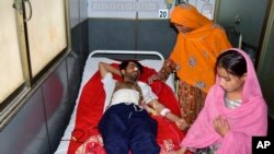 A victim of Friday's deadly bombing is treated in Quetta, Pakistan, Sept. 30, 2023. A suspected suicide bomber blew himself up among a crowd celebrating the Prophet Muhammad's birthday in Pakistan on Friday, killing more than 50 people, authorities said.