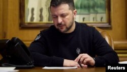 Ukraine's President Volodymyr Zelenskyy speaks on the phone with Germany's Chancellor Olaf Scholz, amid Russia's attack on Ukraine, in Kyiv, April 13, 2024. (Ukrainian Presidential Press Service/Handout via Reuters)