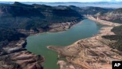 FILE - A view of the Sau reservoir, which is only at 5 percent of capacity, in Vilanova de Sau, Spain, Jan. 26, 2024. A historic drought has shrunk reservoirs to record lows. Experts say the drought is driven by climate change.