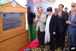 Pakistan's Prime Minister Shehbaz Sharif, center, and other officials pray during the groundbreaking ceremony of the Chashma-5 nuclear power plant in Chashma, Mianwali, Pakistan, July 14, 2023, in this photo released by Press Information Department.