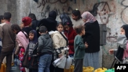 Women and children queue for water in Rafah in the southern Gaza Strip on Feb. 9, 2024.