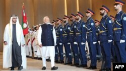 India's Prime Minister Narendra Modi, center, walks next to the President of the United Arab Emirates Sheikh Mohammed bin Zayed Al Nahyan, in Abu Dhabi, in this photo taken and released Feb. 13, 2024, by the Indian Press Information Bureau.