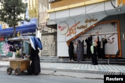 FILE - Afghan beauticians close their beauty salon in Kabul, Afghanistan, July 24, 2023.