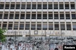 FILE - A barricade covered in barbed wire is placed in front of Lebanon's Central Bank building in Beirut, Lebanon, June 29, 2022.