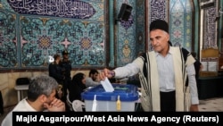 An Iranian man votes at a polling station in Tehran during a snap presidential election on June 28, 2024. (West Asia News Agency/via Reuters)